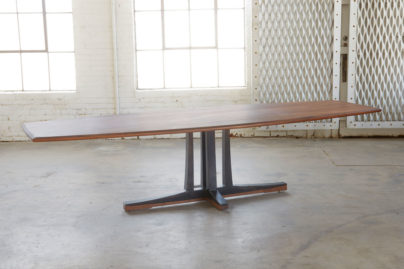 large walnut and steel table in an open room