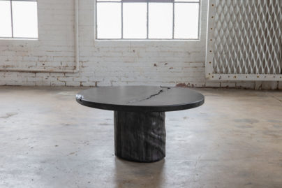 circular cocktail table with crack detail in empty warehouse room