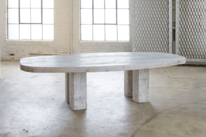 white wood table in front of windows