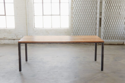 oak and steel table in empty warehouse room